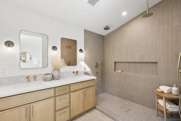 a bathroom with a double vanity sink mirror and
