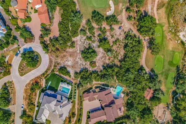 an aerial view of a house with a yard and garden