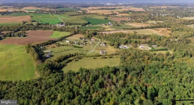 an aerial view of residential houses with outdoor space and city view