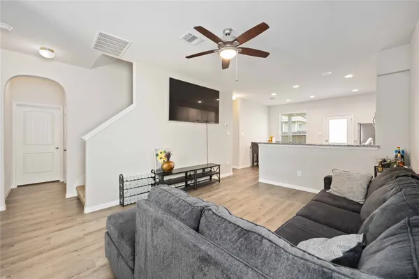 a living room with furniture and a flat screen tv with wooden floor