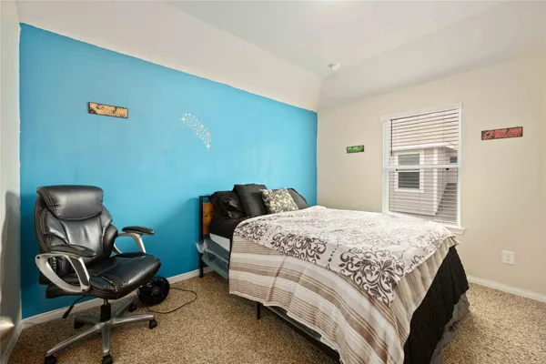 a bedroom with a bed chair and piano