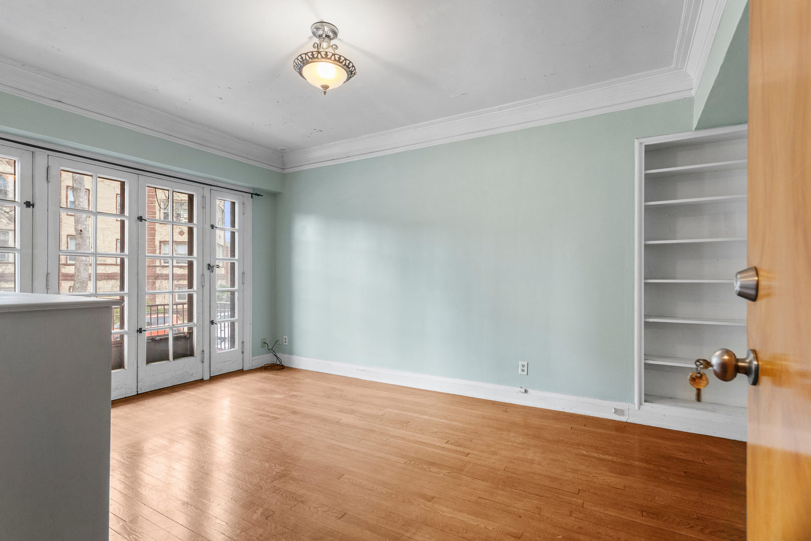 307 North Prairie Street, Unit 3 Champaign, IL 61820 - Photo 15 of 34 a view of an empty room with a window and wooden floor