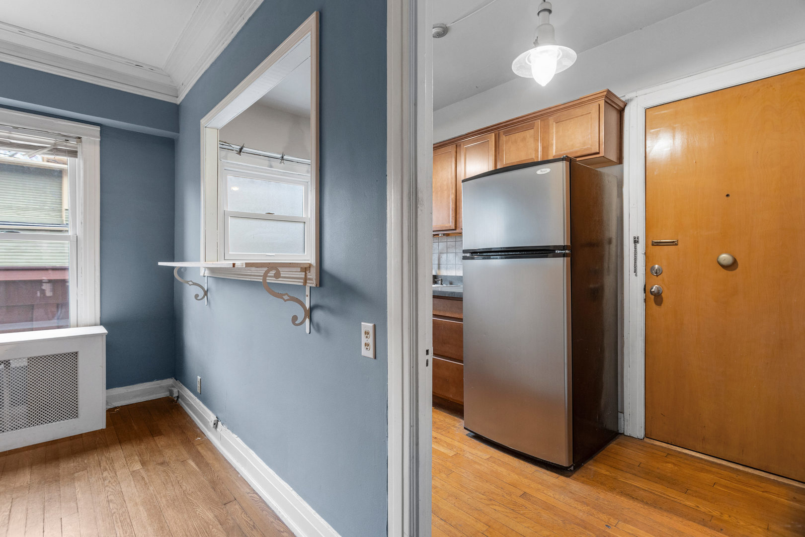 307 North Prairie Street, Unit 3 Champaign, IL 61820 - Photo 20 of 34 a kitchen with a refrigerator and a wooden floor