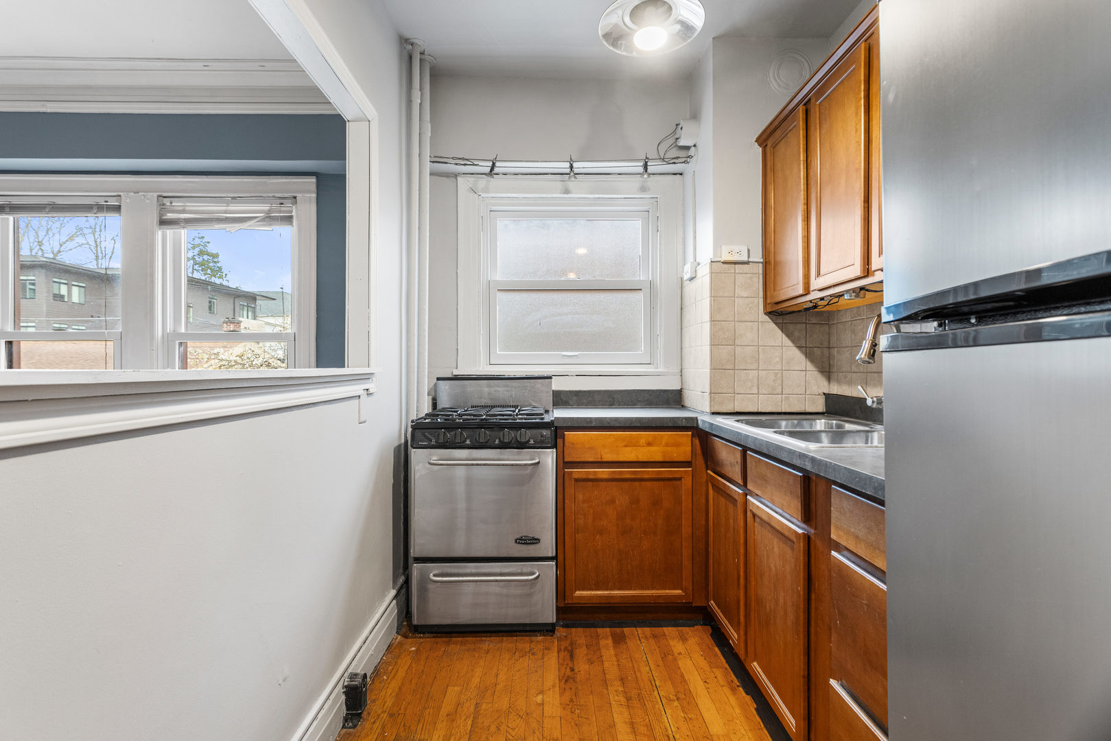 307 North Prairie Street, Unit 3 Champaign, IL 61820 - Photo 21 of 34 a kitchen with stainless steel appliances granite countertop a stove a sink and a refrigerator