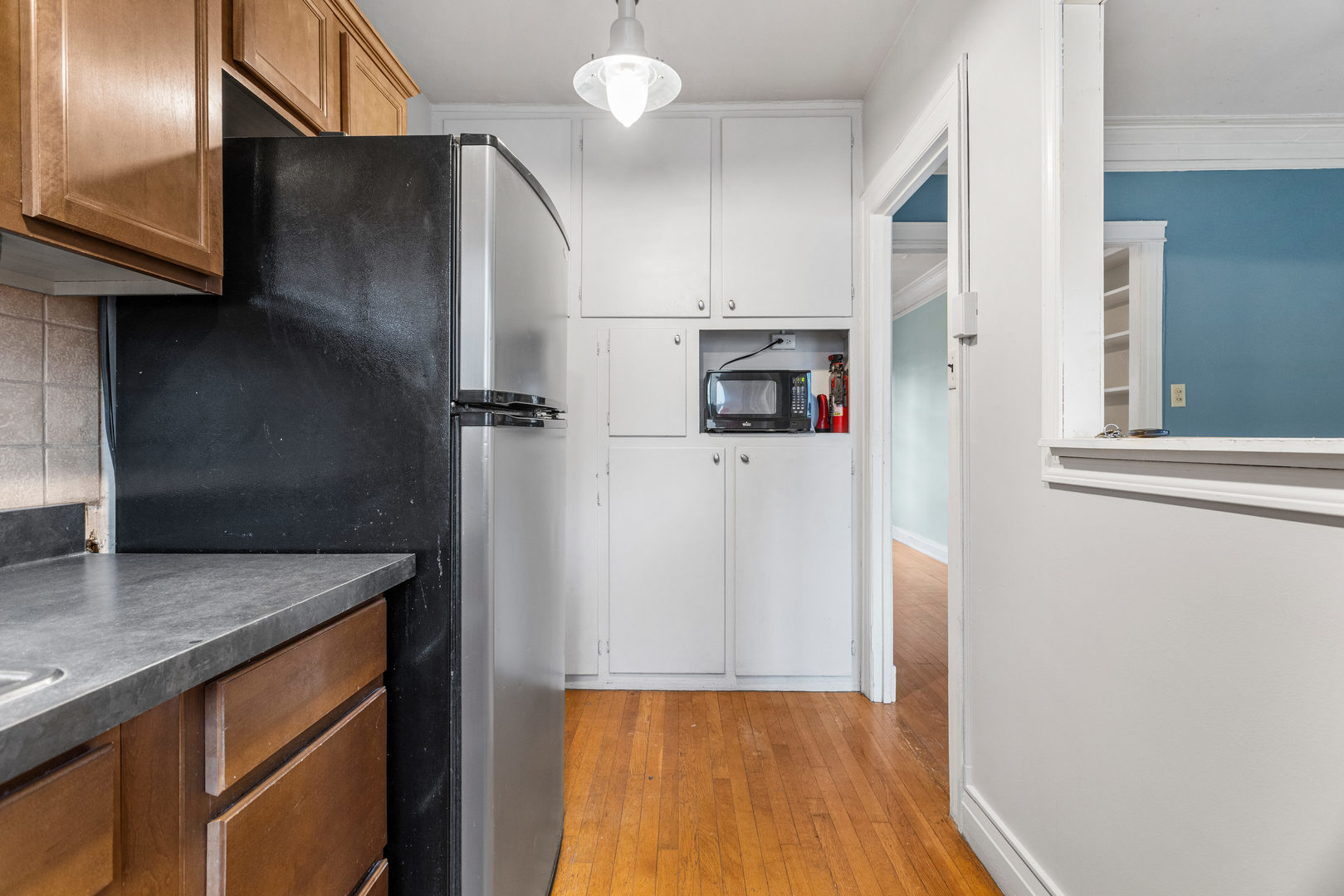 307 North Prairie Street, Unit 3 Champaign, IL 61820 - Photo 23 of 34 a kitchen with stainless steel appliances granite countertop a refrigerator a stove and a sink with wooden floor