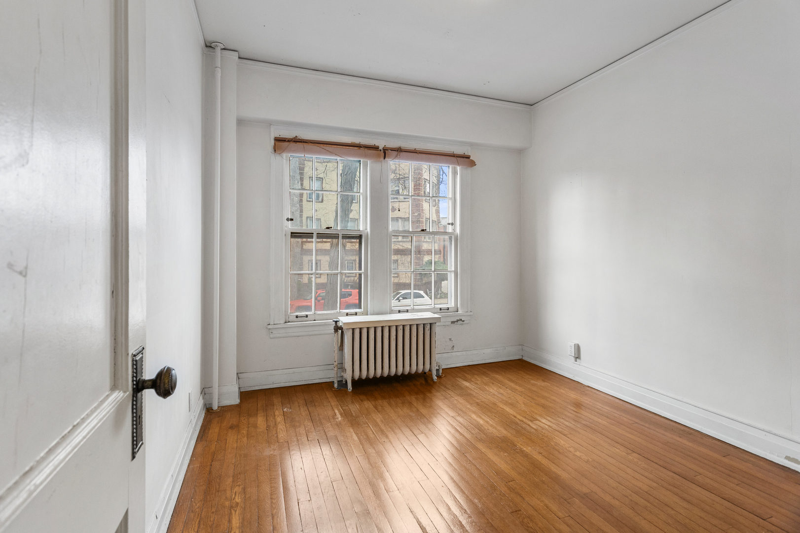 307 North Prairie Street, Unit 3 Champaign, IL 61820 - Photo 28 of 34 an empty room with wooden floor and windows