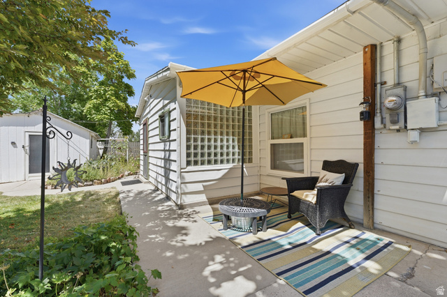 365 North Main Street Fillmore, UT 84631 - Photo 51 of 51 Private patio space featuring horizontal siding, a glass block window, and a concrete pathway to a detached outbuilding