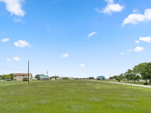 a view of a lake with houses in the back