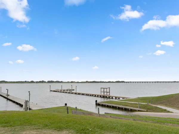 a view of a lake with a yard and outdoor seating