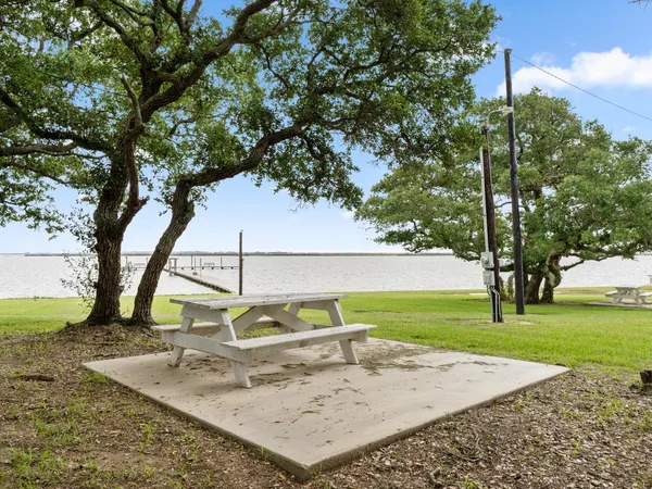 a view of swimming pool with outdoor seating and plants