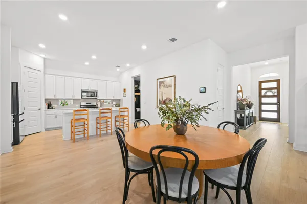 a dining room with furniture and wooden floor