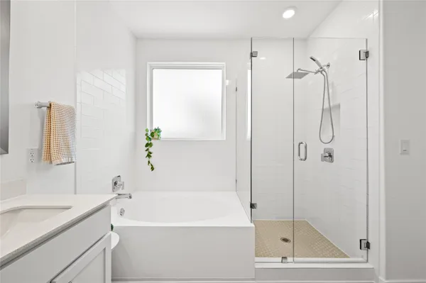 a bathroom with a shower and a bath tub