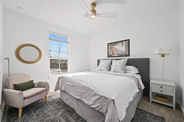 a bedroom with a bed couch and window