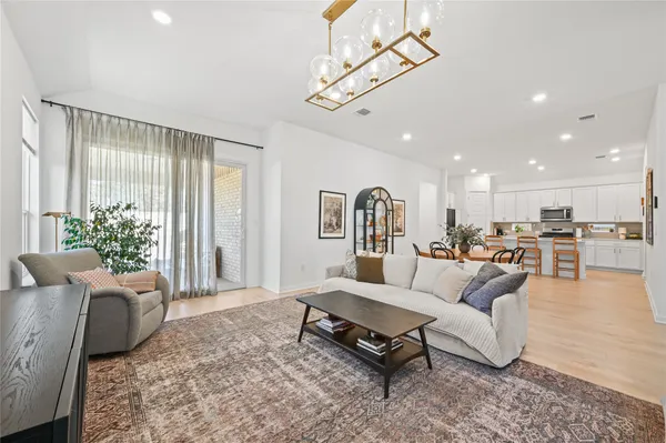 a living room with furniture and a chandelier