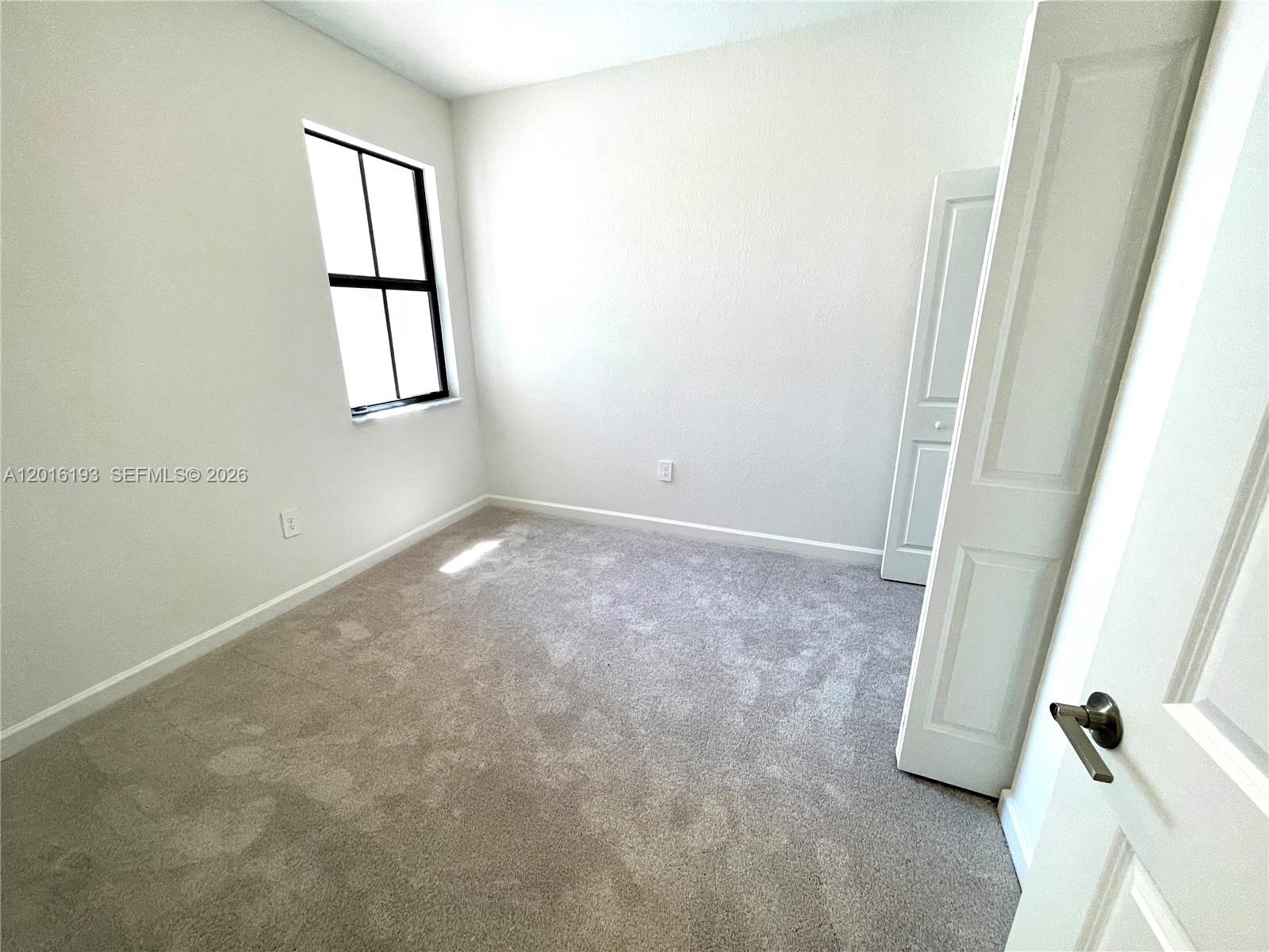 11737 Southwest 245 Terrace Homestead, FL 33032 - Photo 14 of 16 an empty room with windows