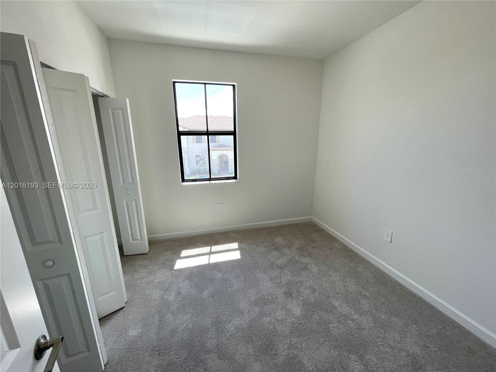 11737 Southwest 245 Terrace Homestead, FL 33032 - Photo 15 of 16 an empty room with windows