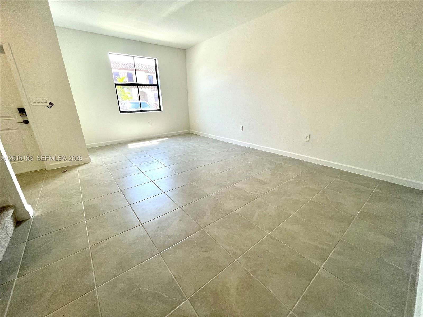 11737 Southwest 245 Terrace Homestead, FL 33032 - Photo 3 of 16 a view of an empty room with a window