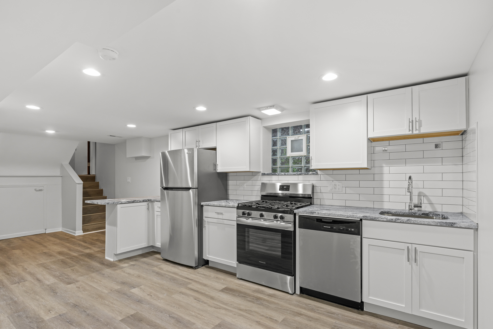 236 Callan Avenue, Unit G Evanston, IL 60202 - Photo 2 of 13 a kitchen with stainless steel appliances kitchen island granite countertop a stove a sink and a refrigerator