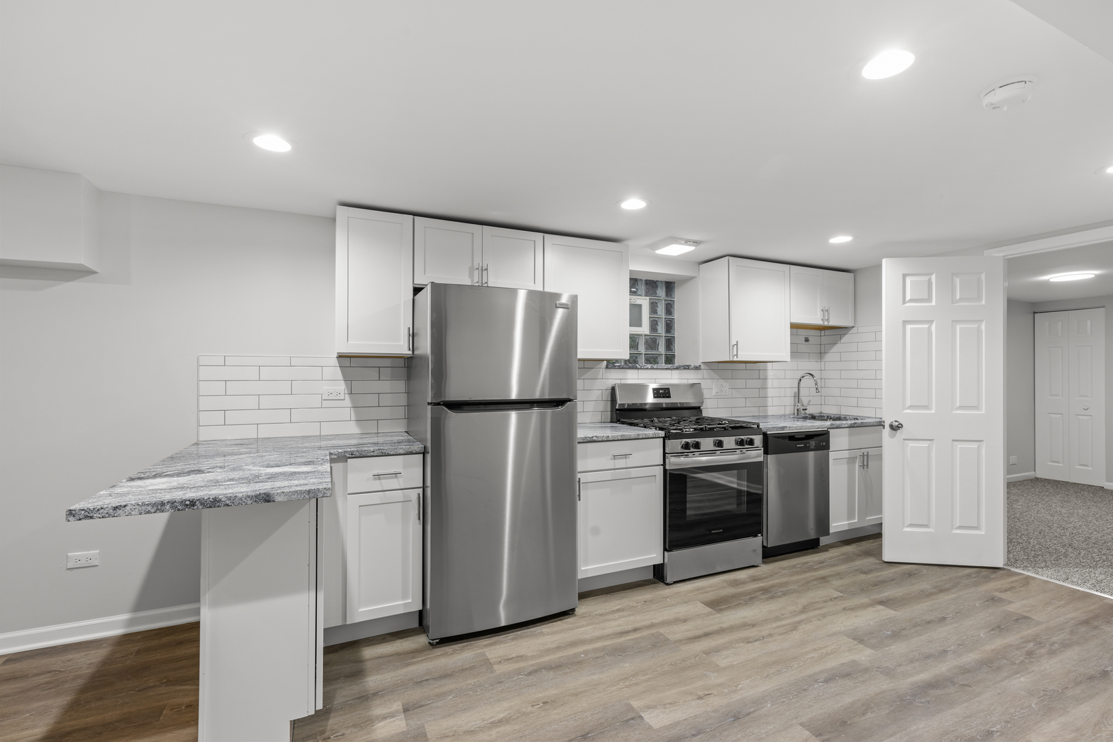 236 Callan Avenue, Unit G Evanston, IL 60202 - Photo 3 of 13 a kitchen with a refrigerator sink and stainless steel appliances
