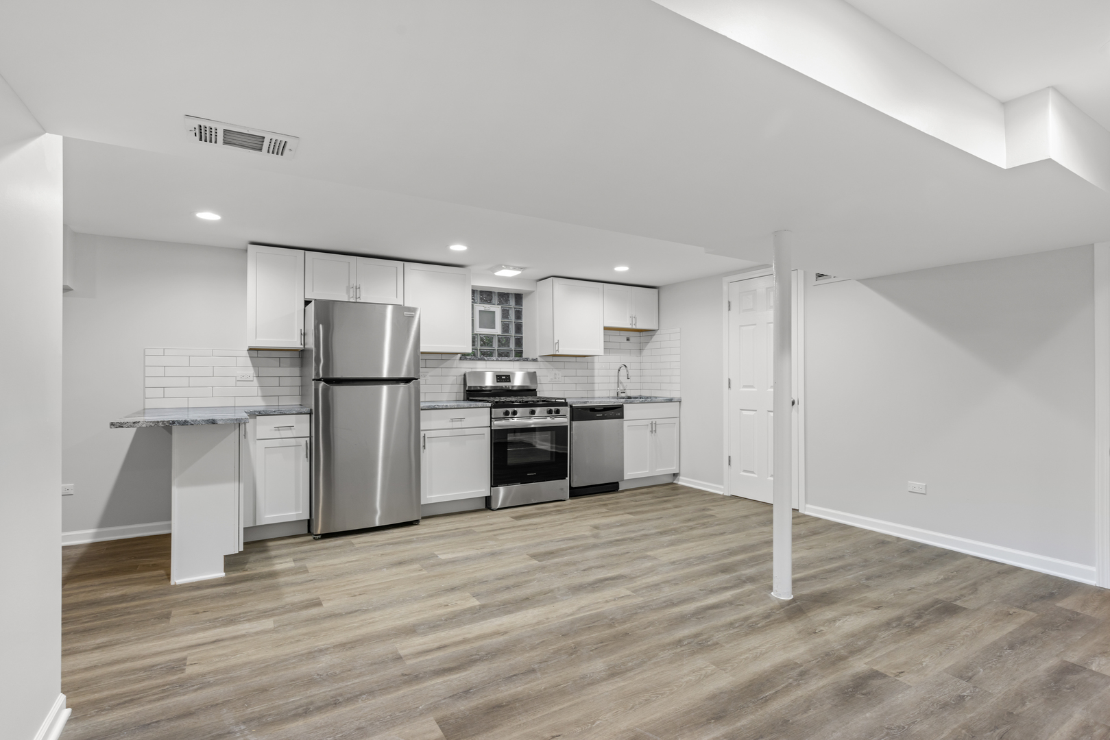 236 Callan Avenue, Unit G Evanston, IL 60202 - Photo 5 of 13 a kitchen with stainless steel appliances a refrigerator and a stove top oven