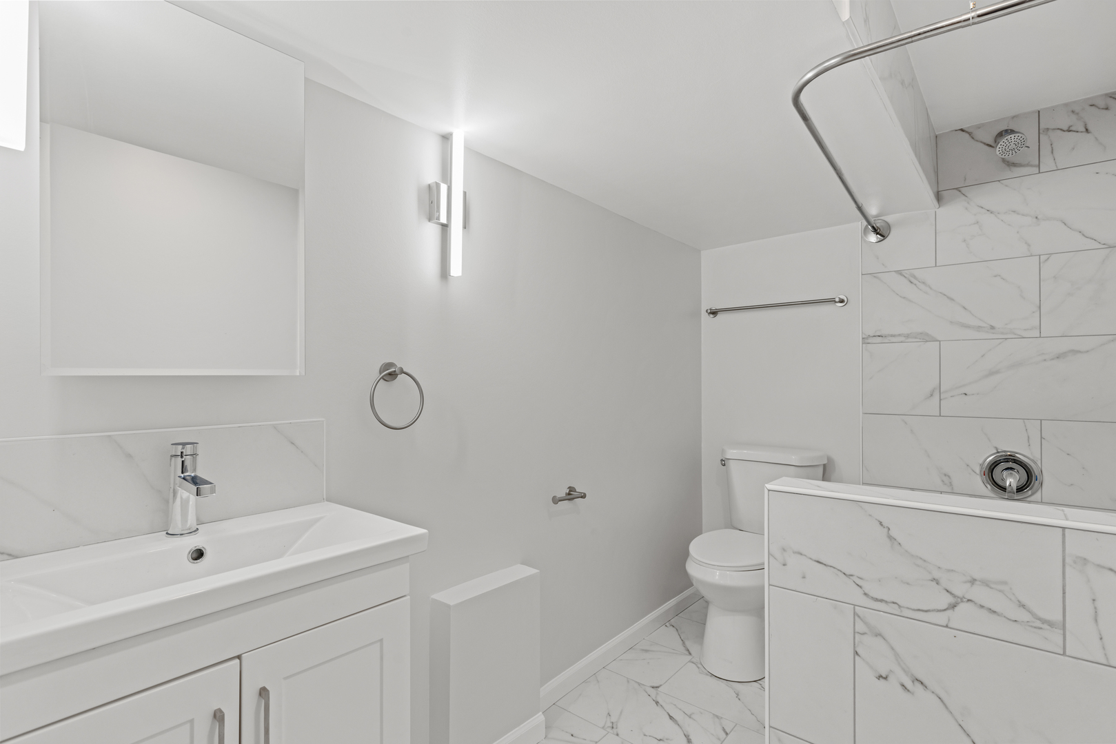 236 Callan Avenue, Unit G Evanston, IL 60202 - Photo 9 of 13 a bathroom with a toilet sink and mirror