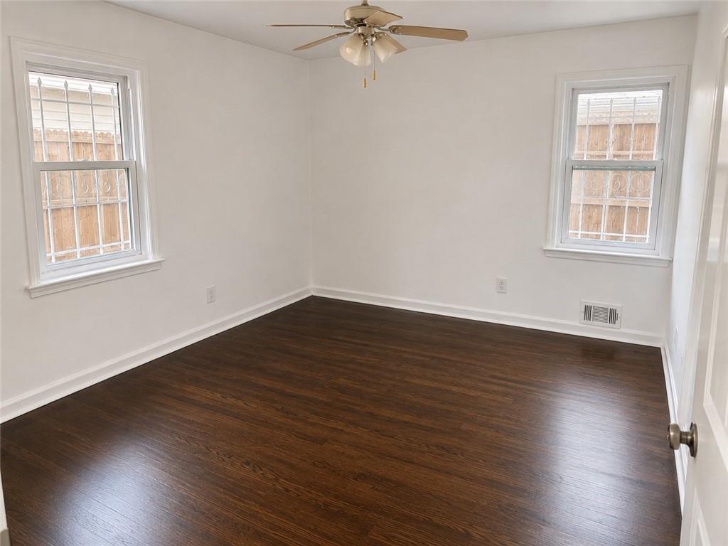 1189 Rock Cut Road Forest Park, GA 30297 - Photo 7 of 23 wooden floor in an empty room with a window