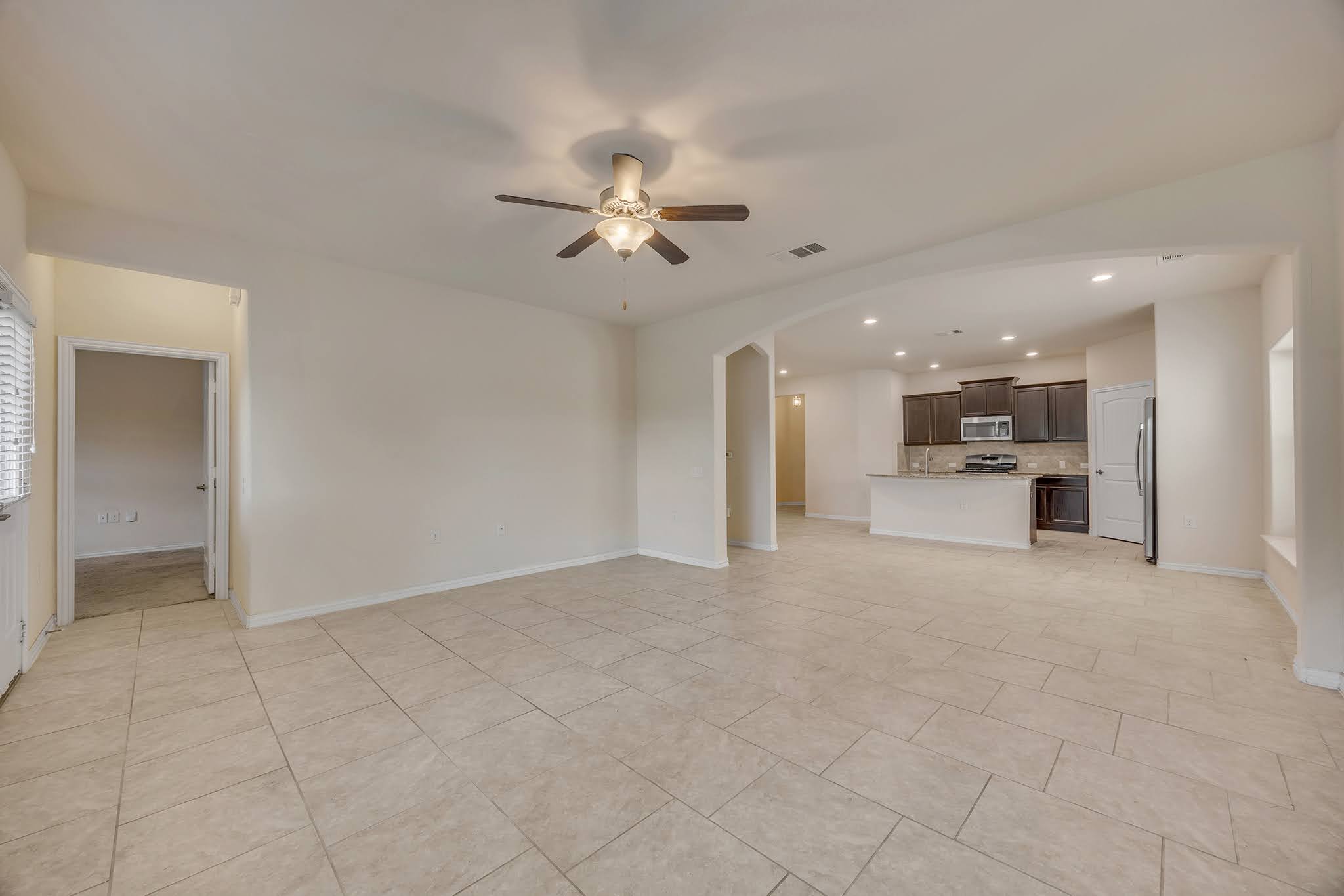 7212 Vail Ridge Street Austin, TX 78744 - Photo 26 of 26 An open floorplan seamlessly connects the living area to a well-appointed kitchen.