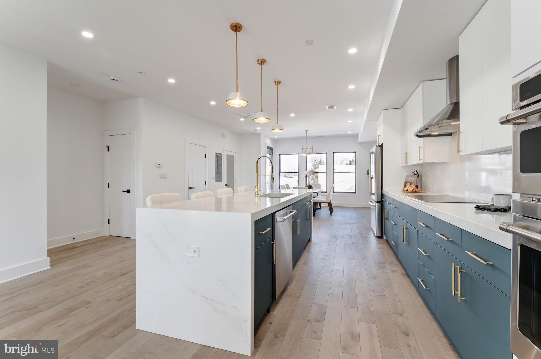 3009 13th Street Northwest, Unit 2 Washington, DC 20009 - Photo 12 of 44 a large kitchen with stainless steel appliances lots of counter space and a sink