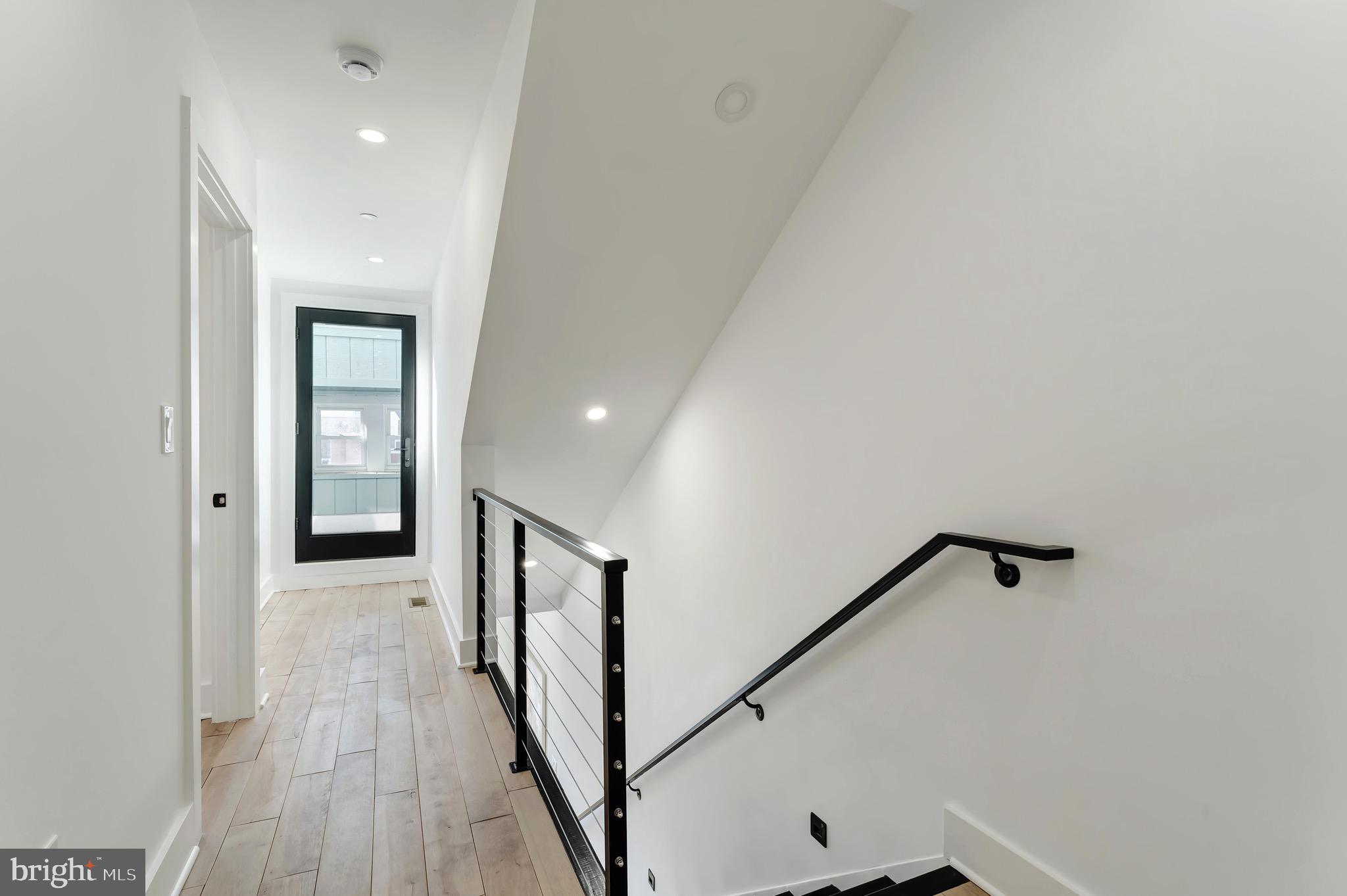 3009 13th Street Northwest, Unit 2 Washington, DC 20009 - Photo 18 of 44 a view of a hallway with wooden floor and staircase