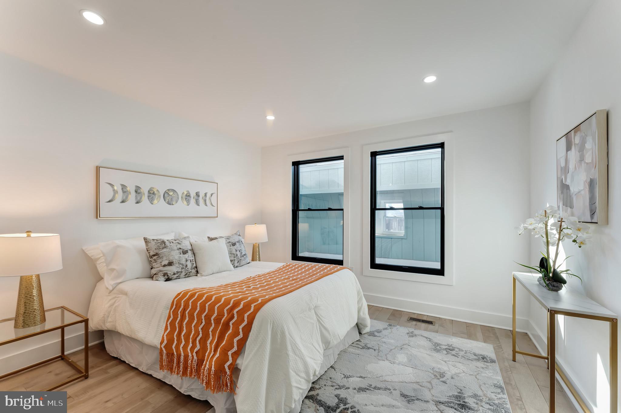 3009 13th Street Northwest, Unit 2 Washington, DC 20009 - Photo 19 of 44 a bedroom with a large bed and a chandelier