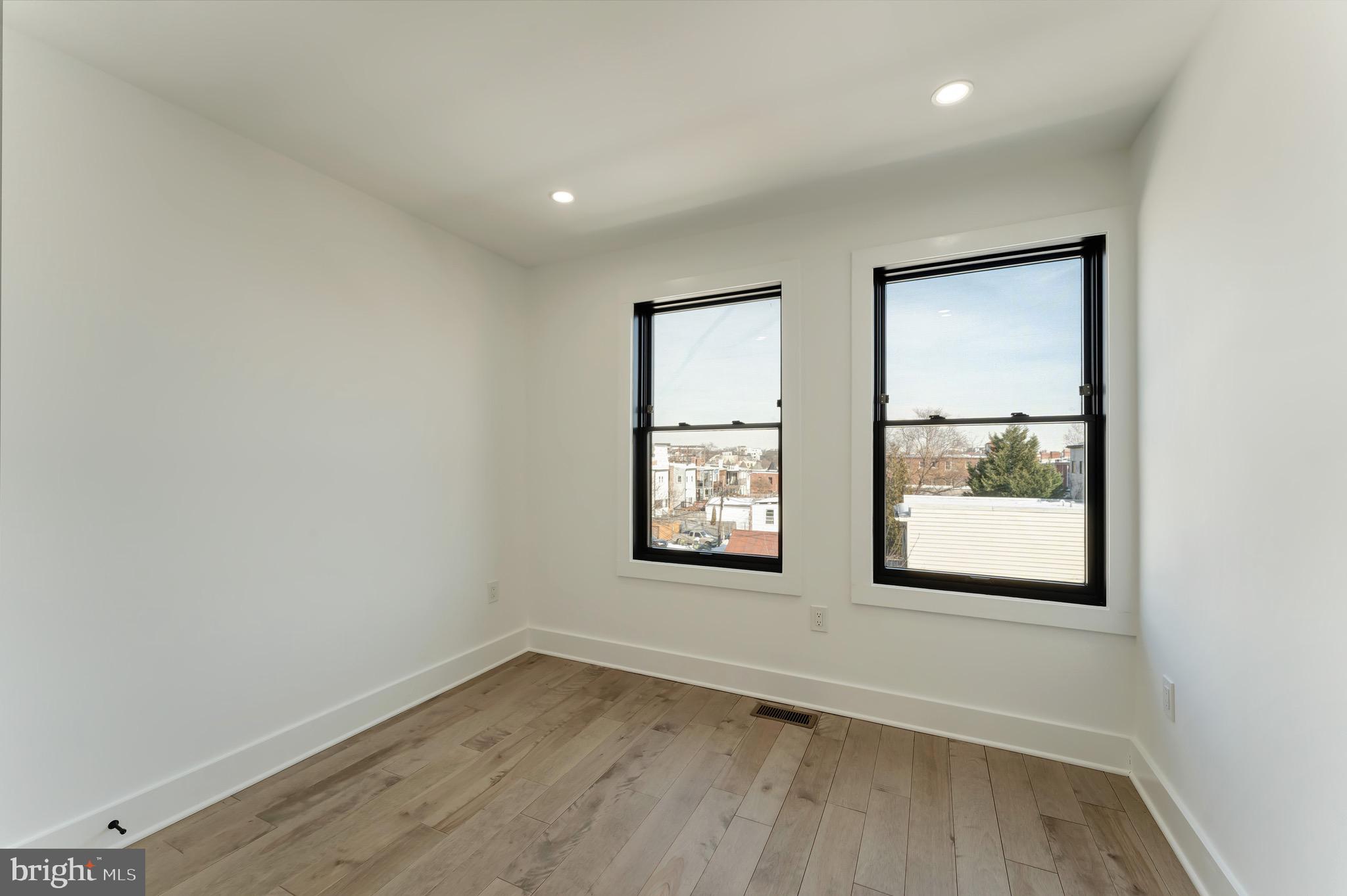 3009 13th Street Northwest, Unit 2 Washington, DC 20009 - Photo 28 of 44 an empty room with wooden floor and windows