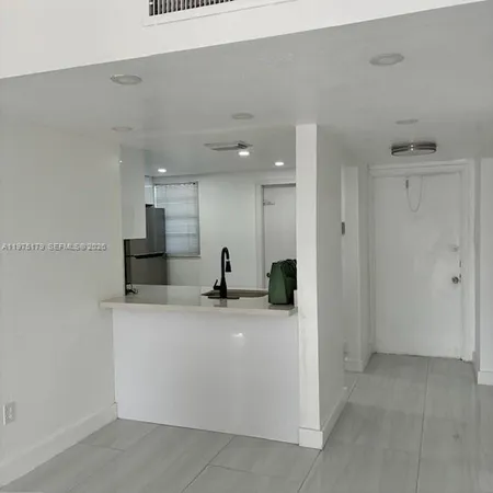 a view of a kitchen with a sink