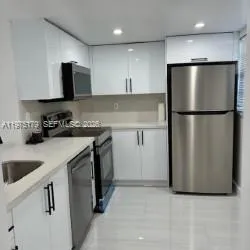 a kitchen with a refrigerator sink and microwave