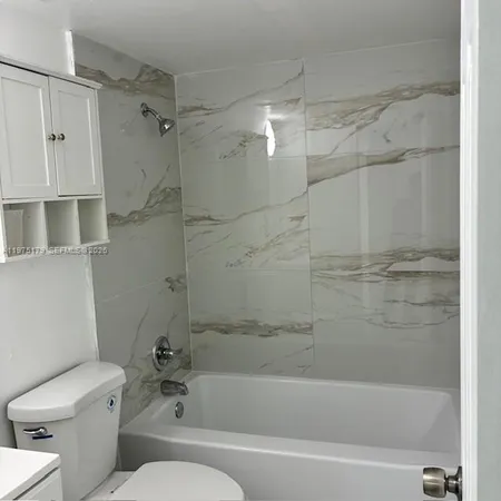 a bathroom with a toilet and a bathtub
