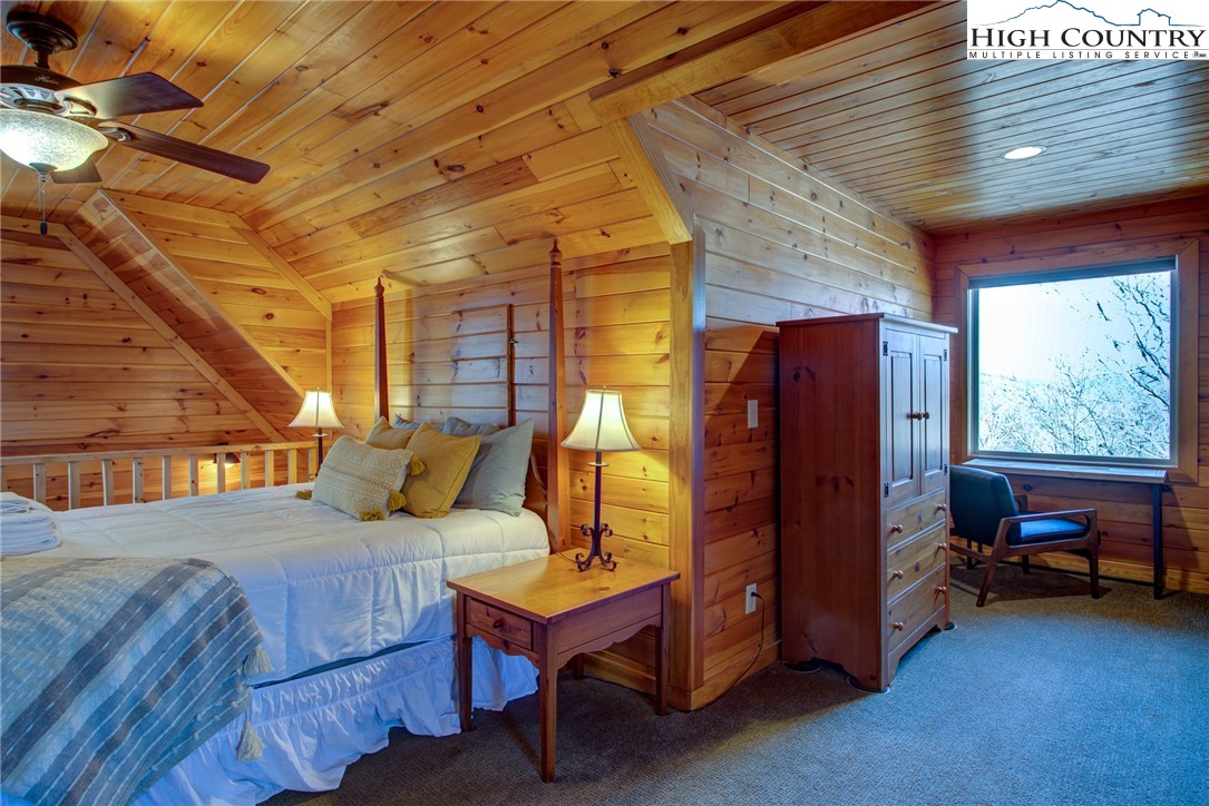1643 Buck Mountain Road Purlear, NC 28665 - Photo 18 of 33 a bedroom with a bed and windows