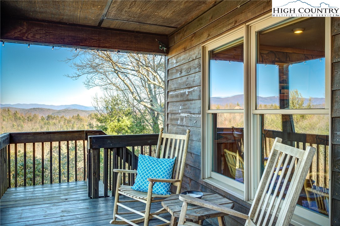 1643 Buck Mountain Road Purlear, NC 28665 - Photo 2 of 33 a view of a porch with furniture and wooden floor