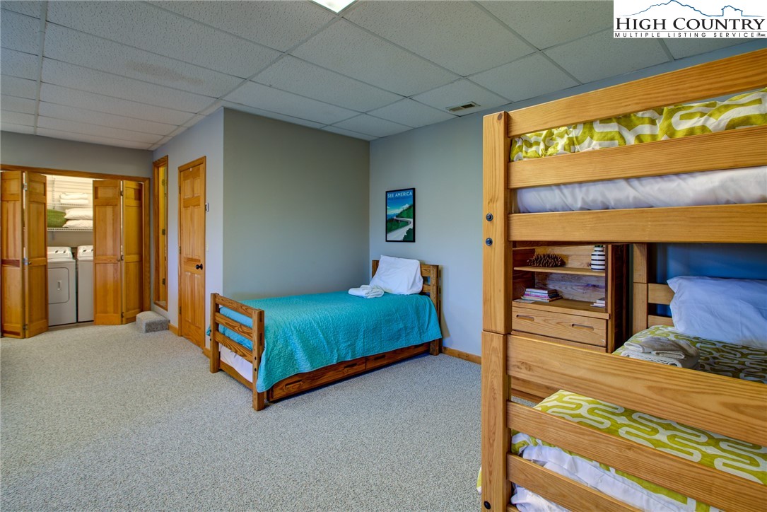 1643 Buck Mountain Road Purlear, NC 28665 - Photo 23 of 33 a bedroom with a bed and window