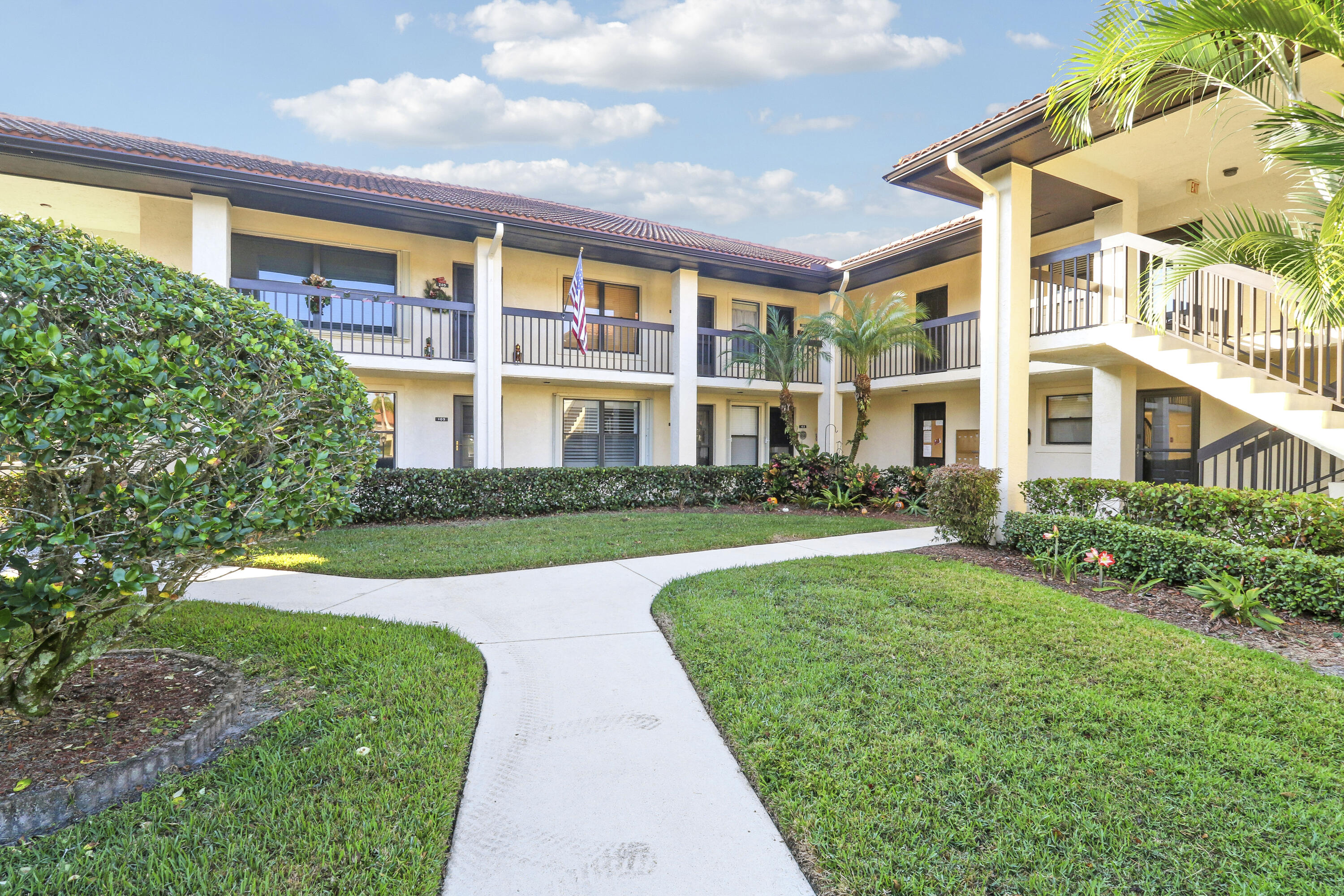 540 Southwest South River Drive, Unit 204 Stuart, FL 34997 - Photo 4 of 14 a view of a building with a yard