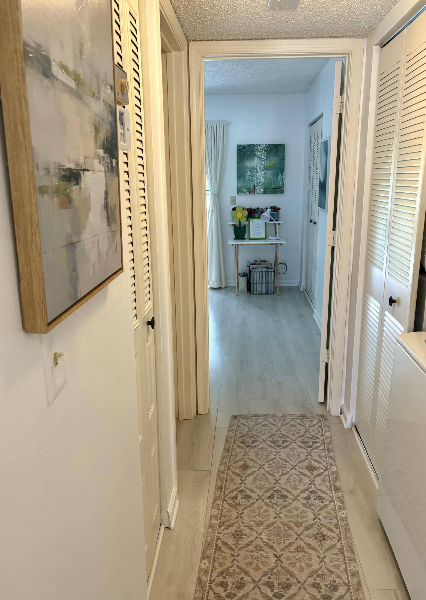540 Southwest South River Drive, Unit 204 Stuart, FL 34997 - Photo 8 of 14 a view of a hallway with a livingroom and a bathroom
