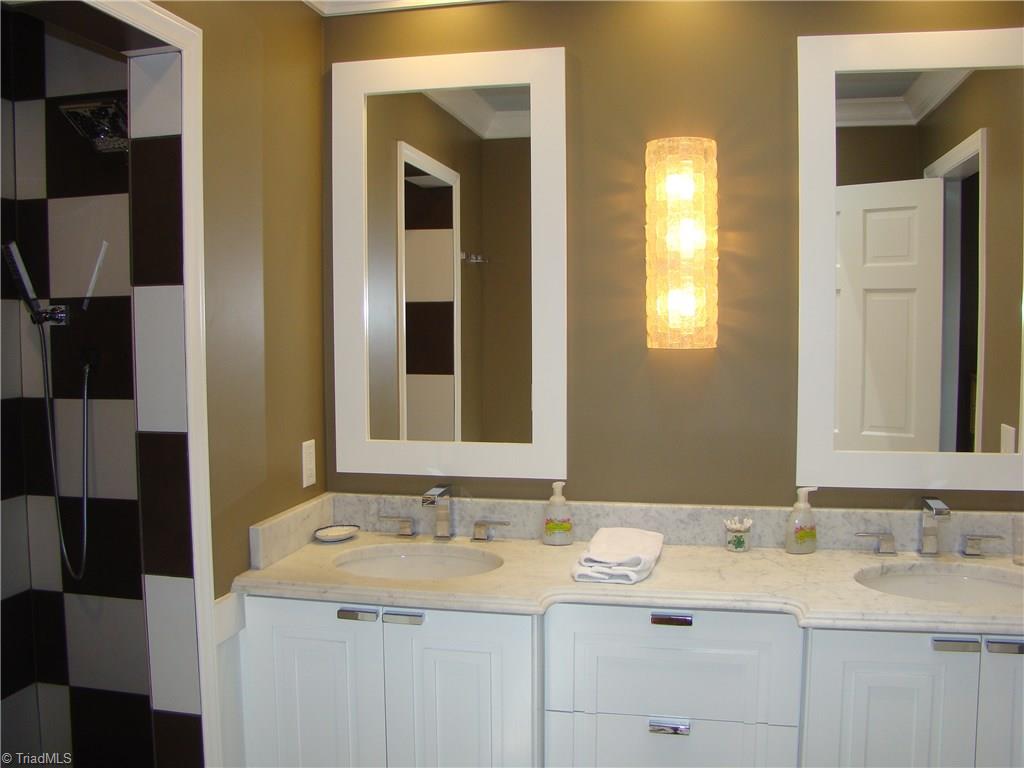 3614 Pinetop Road Greensboro, NC 27410 - Photo 14 of 30 Updated master bath has dual sink vanity, separate water closet, and walk in shower.