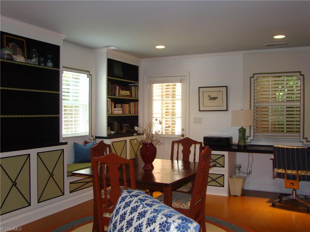 3614 Pinetop Road Greensboro, NC 27410 - Photo 23 of 30 More built-ins, with door leading to back yard, driveway and quaint looking storage shed.