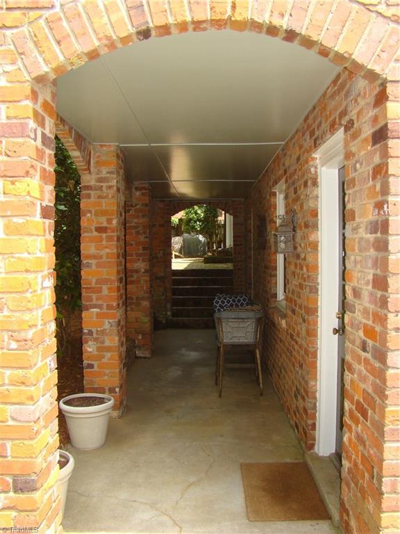 3614 Pinetop Road Greensboro, NC 27410 - Photo 25 of 30 Lower level breezeway accesses the back yard and driveway, as well as the upper level brick patio.