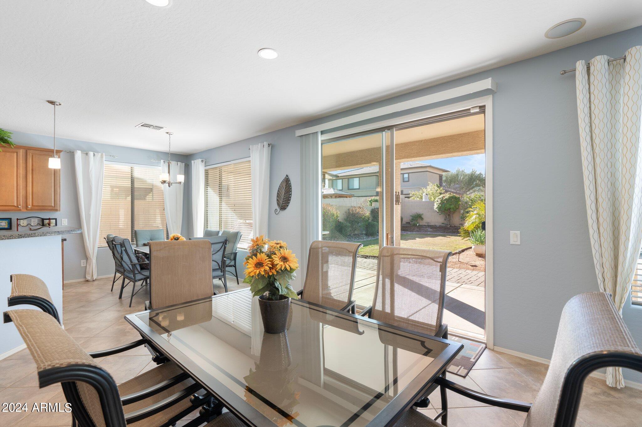 4427 West Summerside Road Laveen, AZ 85339 - Photo 15 of 72 a dining room with furniture and wooden floor