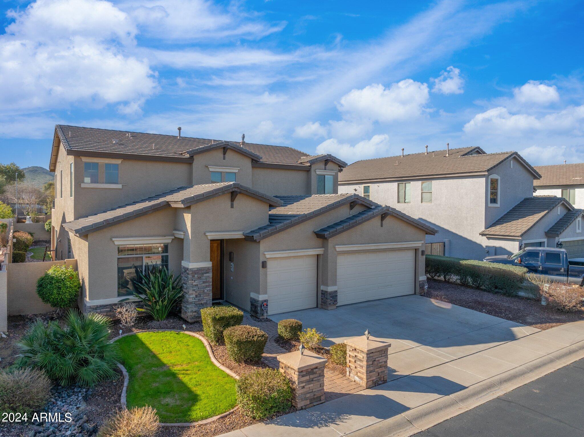 4427 West Summerside Road Laveen, AZ 85339 - Photo 2 of 72 a view of a white house next to a yard