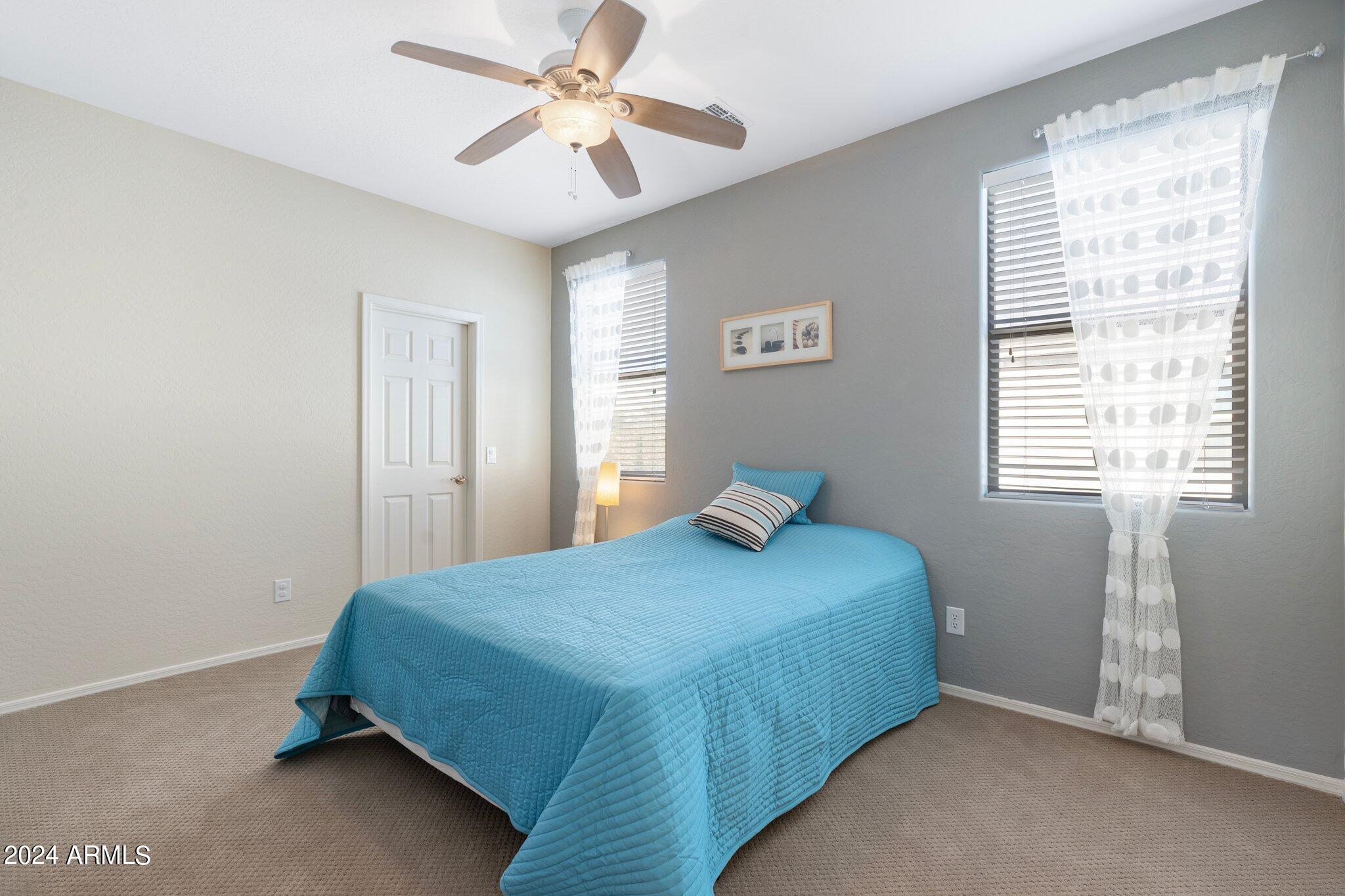 4427 West Summerside Road Laveen, AZ 85339 - Photo 24 of 72 a bedroom with a bed and a window