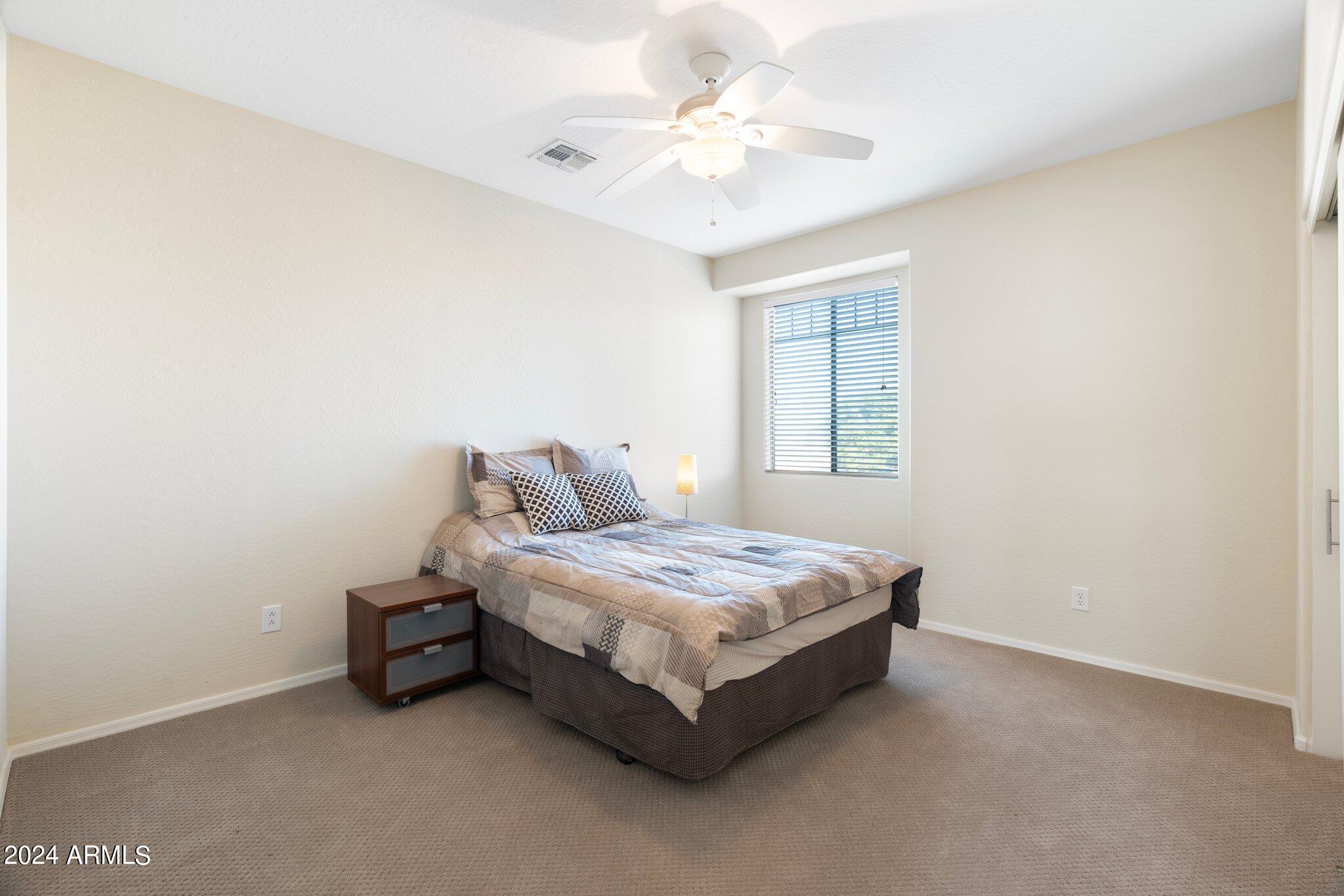 4427 West Summerside Road Laveen, AZ 85339 - Photo 26 of 72 a spacious bedroom with a bed and a chandelier