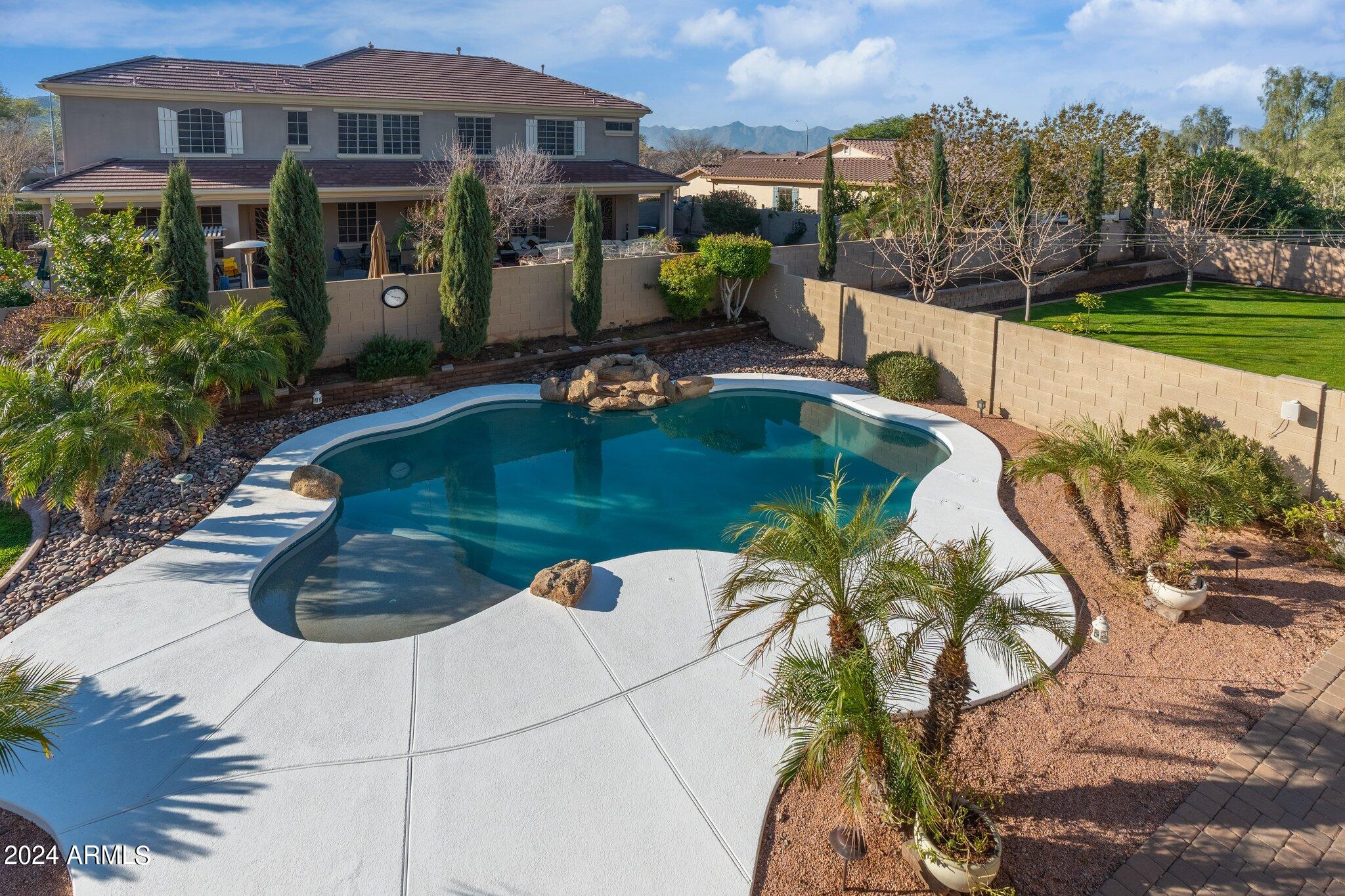 4427 West Summerside Road Laveen, AZ 85339 - Photo 27 of 72 a view of a swimming pool with a garden