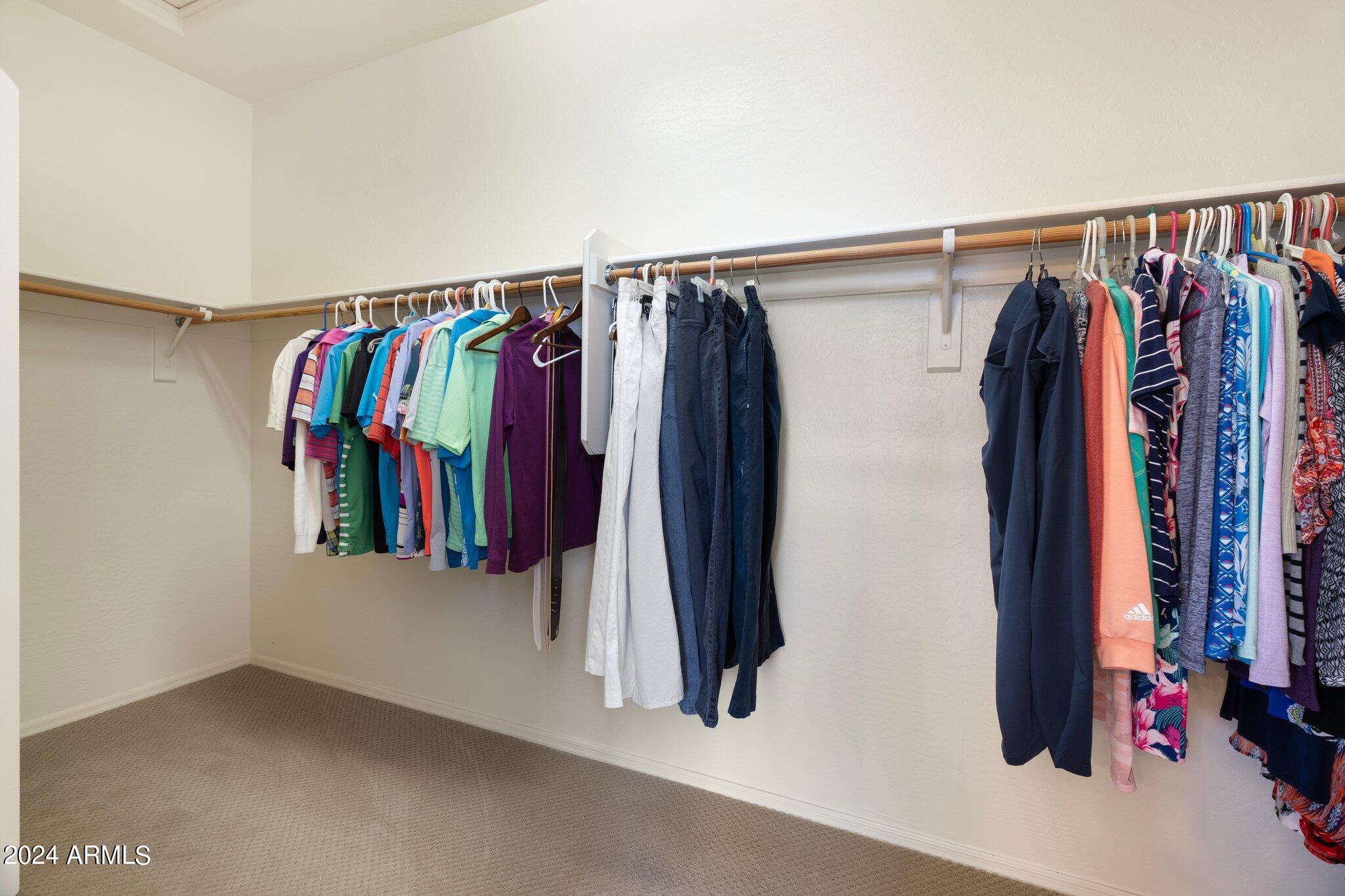 4427 West Summerside Road Laveen, AZ 85339 - Photo 31 of 72 a view of walk in closet with clothes