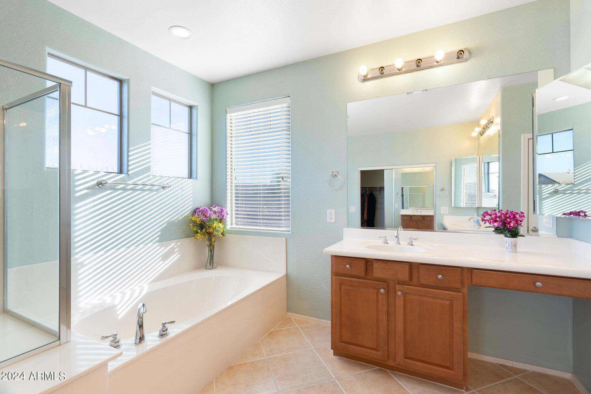 4427 West Summerside Road Laveen, AZ 85339 - Photo 32 of 72 a spacious bathroom with a tub sink and mirror