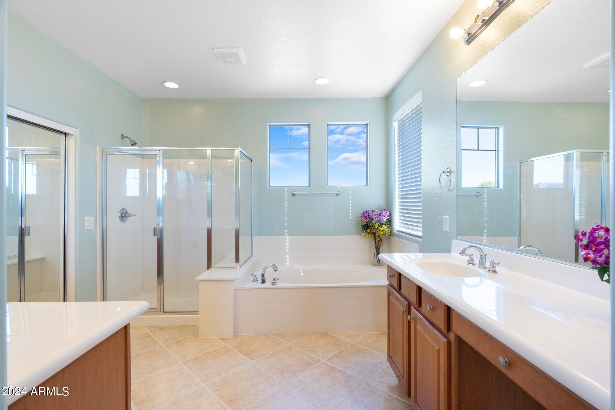 4427 West Summerside Road Laveen, AZ 85339 - Photo 34 of 72 a bathroom with a tub sink shower and mirror